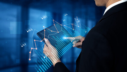 A business professional engaged in digital data analysis using a tablet that showcases financial stock market charts and graphs, set in a modern office environment. Scalp