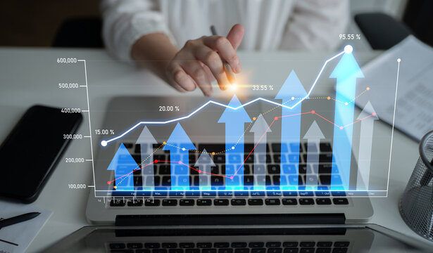A modern workspace featuring a laptop with graphs and statistics indicating business growth and performance metrics, highlighting data analysis and strategic planning. Scalp