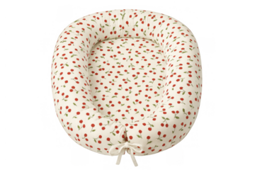 Baby nest or newborn lounger with cherry print, providing a cozy portable bed for infant sleep on transparent background