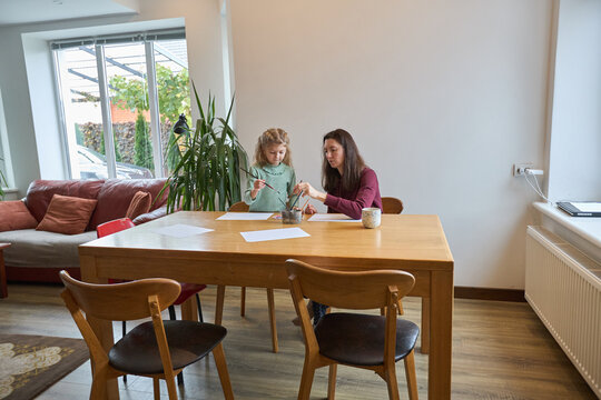 Mother and daughter engaging in art activity at home - Powered by Adobe