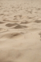 A sandy beach with a few footprints in the sand