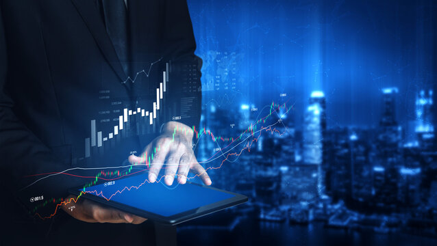 A business professional engages with a tablet displaying financial graphs in a modern cityscape at night, highlighting trends and analytics for stock market insights. Scalp - Powered by Adobe