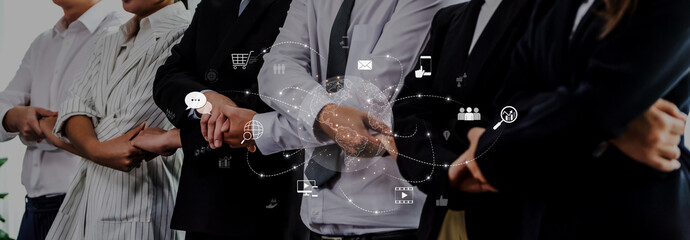 A diverse group of business professionals in formal attire showcases collaboration in a modern workspace with digital icons symbolizing technology and communication. Trope
