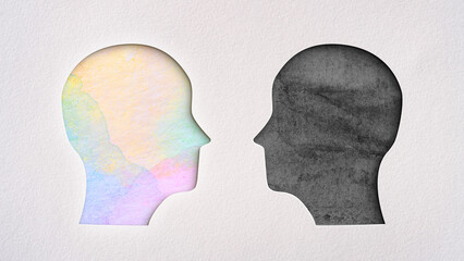 Two head silhouettes visible beneath the cut paper, one in bright and vibrant watercolors and the...
