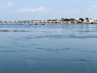 The sacred Kooduthurai confluence where Bhavani and Kaveri rivers meet, with a bridge spanning...
