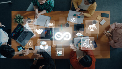 A diverse business team engages in a collaborative meeting focused on sustainability initiatives, showcasing digital icons and themes of eco-friendliness and innovation. Trope