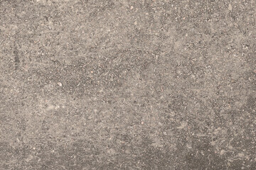 Concrete texture. Pebbles of different colors and signs of aging are visible.