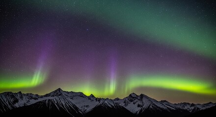 Magical northern lights phenomenon with vibrant green and purple colors dancing across a clear, starry night sky, illuminating the peaks of a majestic, snow-covered mountain range