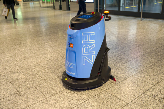 Close-up of light blue cleaning robot at terminal building at Swiss Z&uuml;rich Airport on an autumn morning. Photo taken November 22nd, 2025, Zurich Kloten, Switzerland.