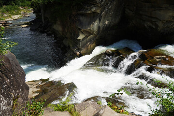 Small mountain waterfall, rapids of a mountain river