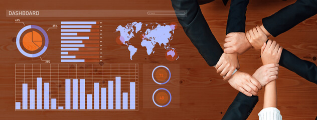 Diverse hands unite over data visuals on a dashboard, symbolizing teamwork and collaboration for...