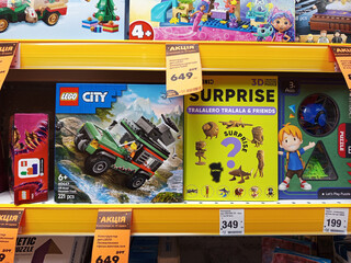 Naklejka premium Zvyagel, Ukraine - November 20, 2025: LEGO City building set featuring a military vehicle on display in a toy store, showcasing vibrant colors and engaging design for children