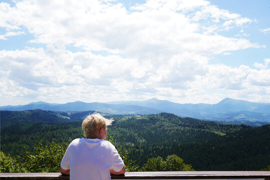 A guy looks at the beautiful mountains, Carpathians, Ukraine