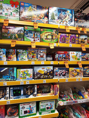 Fototapeta premium Zvyagel, Ukraine - November 20, 2025: Colorful display of LEGO toy sets in a retail store, showcasing various themes like City, Fortnite, and Minecraft, perfect for children's creativity and playtime
