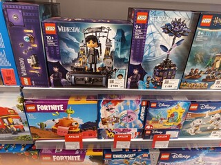 Obraz premium Zvyagel, Ukraine - November 20, 2025: LEGO sets displayed on store shelf featuring Wednesday, Fortnite, and Disney themes, showcasing vibrant packaging and engaging designs for children