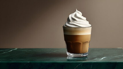 Creamy coffee beverage with whipped topping on marble