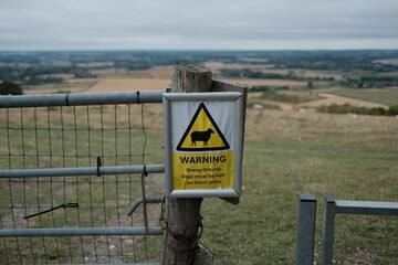 warning sign on a fence for sheep