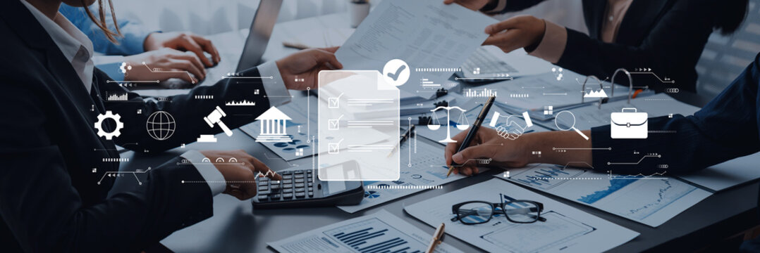 A business team discusses project strategies while analyzing financial data and charts in a modern office setting, showcasing collaboration and professionalism. Trope