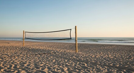 A solitary volleyball net stands on a tranquil sandy beach during a beautiful golden hour sunset, with gentle waves rolling in from the calm ocean under a clear gradient sky