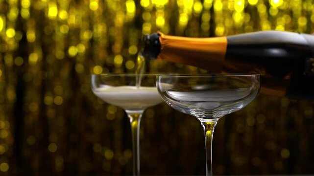 pouring champagne wine from bottle in a coupe glasses. champagne poured in a champagne glases. Sparkling wine pouring into glases. Close up pour champagne in glases.Celebration champagne new years e