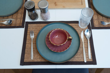 Elegant table setup with a vintage teacup adding warmth and charm to a serene dining atmosphere.