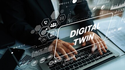 Professional using laptop to demonstrate concept of digital twin technology with data graphics and modern interface elements. Asymptotic smart data analytic.