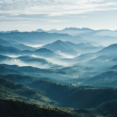 Captured from a wide perspective overlooking vast mountain scenery with drifting mist