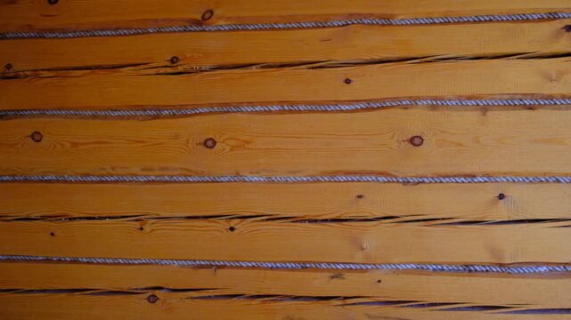 Log wall with jute insulation. Old village house, Old logs and tow. Close-up. Cottage. Timber beam wall cabin. Eco natural materials house construction concept