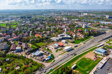 Aerial panorama of Krakow, Poland, showing the Podgórze district. View of the major Nowohucka road intersecting dense urban allotment gardens and residential areas.