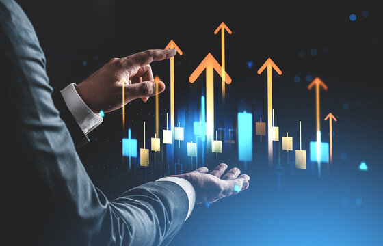Businessman interacting with glowing upward arrows and stock chart bars on futuristic digital interface background as a success and growth concept.