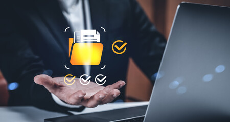 Businessman presenting secure digital folder with checkmarks and document icons in creative concept on modern technology background.