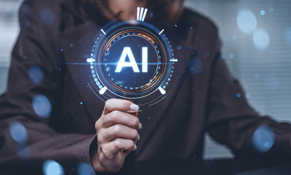 Business person holding magnifying glass with glowing AI symbol, futuristic digital interface elements, concept of artificial intelligence technology advancement.