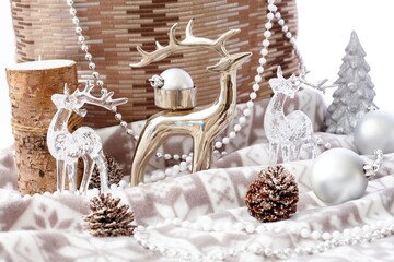 Christmas still-life with reindeer, pineal, candle and ornaments.