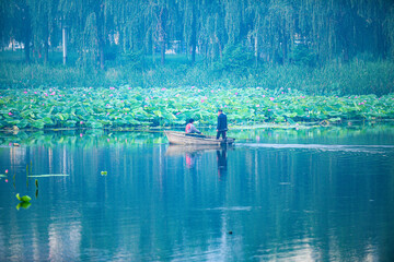 Tangshan City, Hebei Province, China - July 11, 2024: A fisherman drives a small fishing boat to...