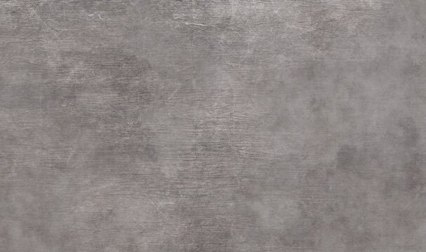 A dark, cool grey background with a distressed, textured surface. Features light scratches, smudges, and subtle cloud-like variations in tone across the rough material