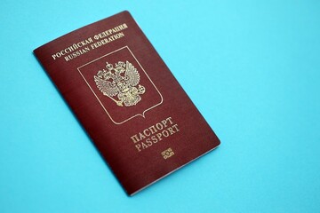 Russian Federation red passport on light blue table background close up. Concept of travel and tourism