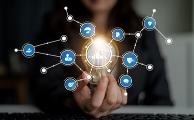 This image depicts a light bulb held by a person, surrounded by icons illustrating data trends, business solutions, and innovative technologies, symbolizing creativity and connectivity. Crux