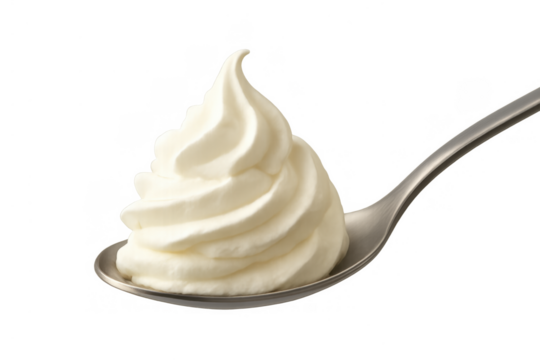 Whipped cream swirl on a metallic spoon, showing soft texture and airy volume, sweet topping ready for dessert