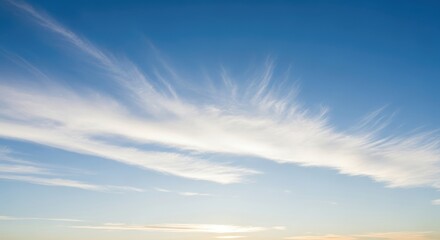 Obraz premium Clear Blue Sky with Wispy White Cirrus Clouds and Gentle Horizon Light