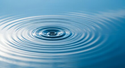Water Droplet Causing Ripples on Blue Surface