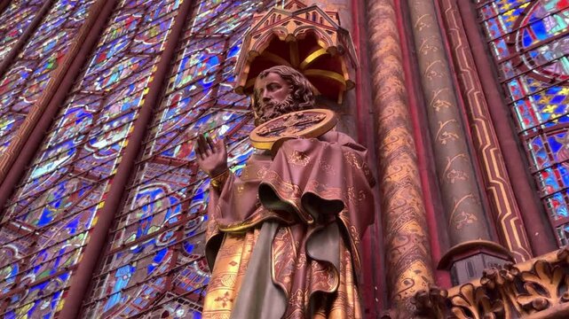 Interior details of Sainte-Chapelle in Paris, France, featuring stained glass windows and Gothic architecture, ideal for travel, history, and European heritage footage.
