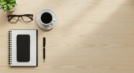 Overhead view of a desk with a notebook, smartphone, pen, glasses, coffee cup and plant, creating a workspace or office scene.