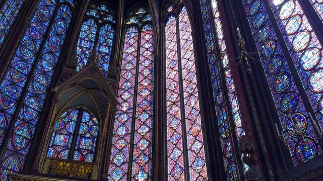 Interior details of Sainte-Chapelle in Paris, France, featuring stained glass windows and Gothic architecture, ideal for travel, history, and European heritage footage.