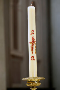 Saint Agatha Church. The Paschal Candle with Alpha et Omega.  Rumilly. France.