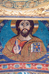 San Clemente Basilica.   Apse mosaic.  Medieval mosaic bust of Christ with benediction gesture and jeweled book above decorative frieze.