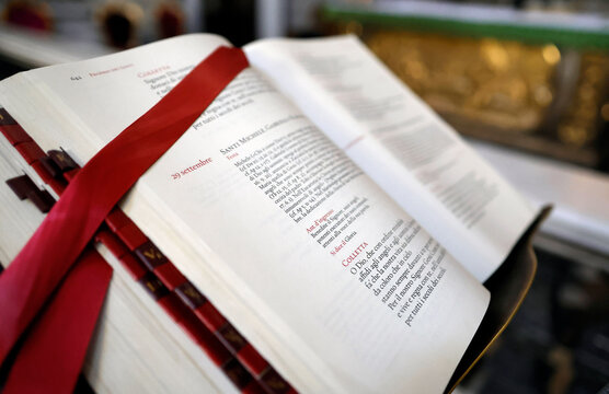 Open Roman Missal with red ribbons marks September 29, prayer for Saints Michael, Gabriel, and Raphael.