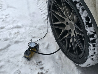 Car Tire Inflation in Snowy Winter Conditions