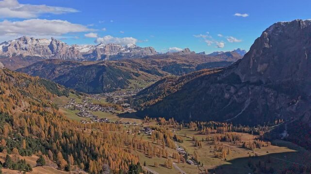 Aerial view of Corvara village in autumn valley, Dolomites, Northern Italy