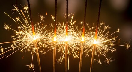 Sparkling celebration golden sparklers burning brightly against a dark background symbolizing joy and festivity