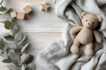 Baby announcement background with teddy bear on neutral linen blanket, wooden star blocks, eucalyptus leaves on white distressed wood surface for nursery baptism or reveal.